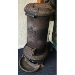 An unusual cast iron stove with hinged top.