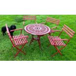 A good set of four patio chairs together with a table in red.