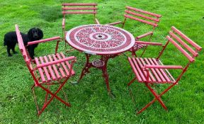 A good set of four patio chairs together with a table in red.