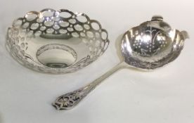 A silver tea strainer with pierced decoration together with a bon bon dish.