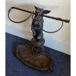 A good wrought iron stick stand attractively decorated with a dog.