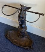 A good wrought iron stick stand attractively decorated with a dog.