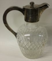 A Edwardian silver and glass claret jug.
