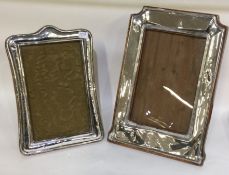 Two stylish silver and oak mounted picture frames.