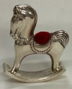 A novelty silver pin cushion in the form of a horse.