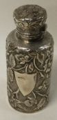A Victorian chased silver scent bottle with glass stopper embossed with flowers.