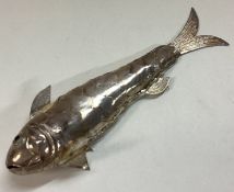 A silver figure of a fish.