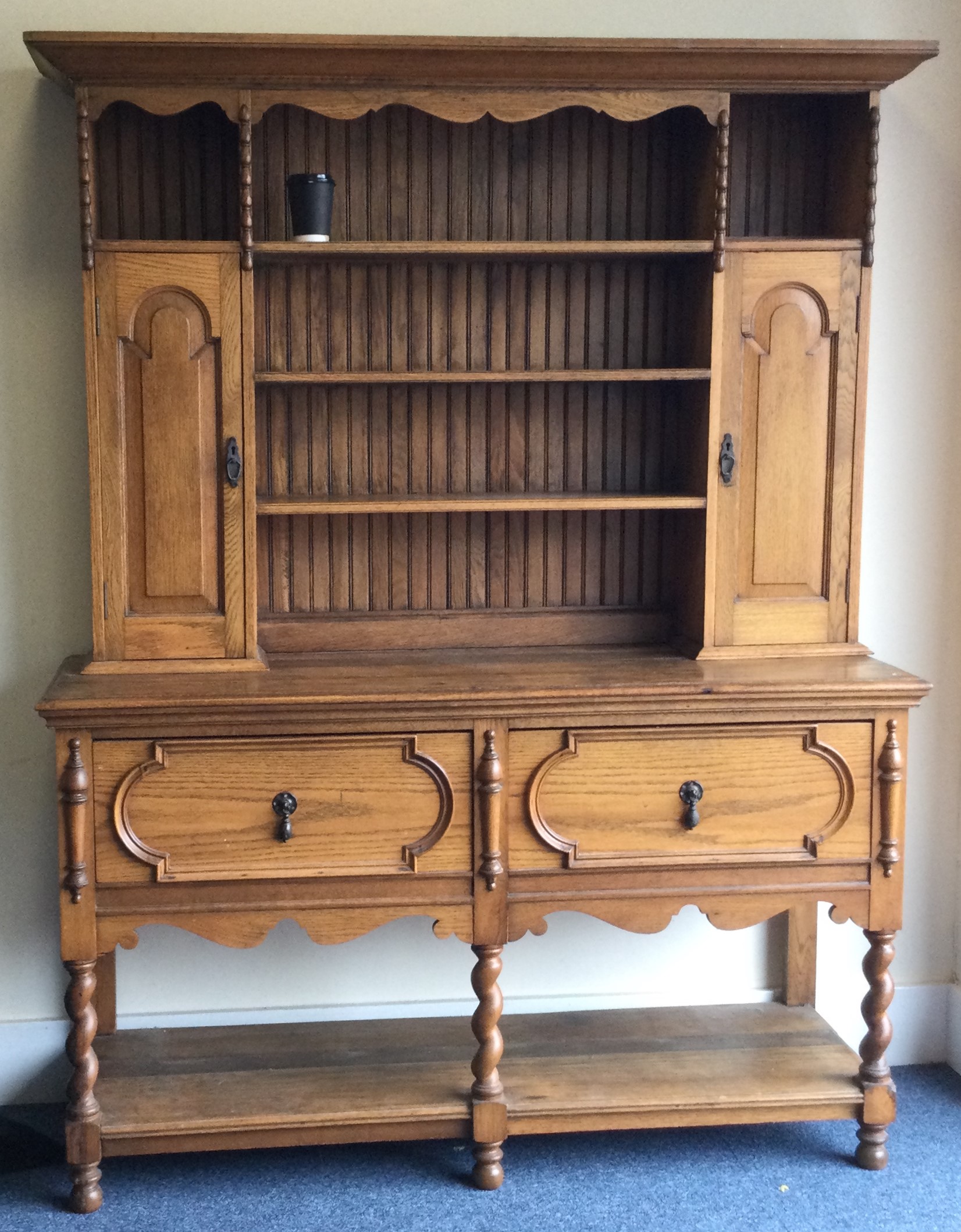 A large oak kitchen dresser with panelled back.