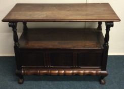 A small mahogany hinged top settle.