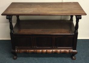 A small mahogany hinged top settle.