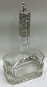 A large Continental embossed silver and cut glass scent bottle.