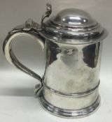 A George I silver lidded tankard. Marked to body and lid. London 1725.