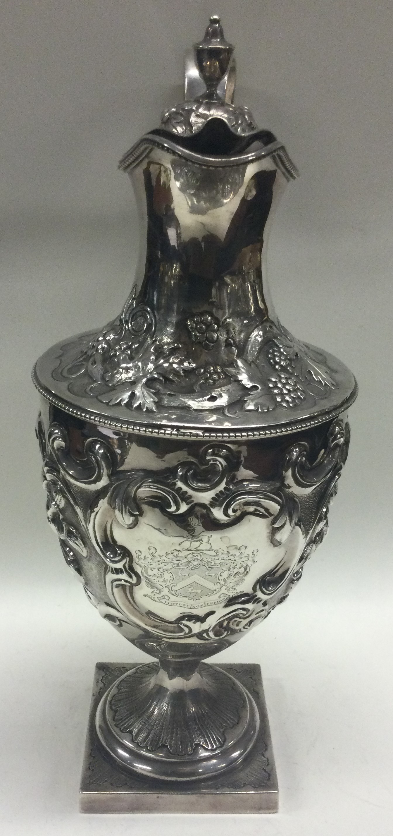 A large chased 18th Century silver wine jug with central armorial. London 1777. - Image 3 of 4