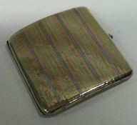 A Continental silver mixed metal and gem stone cigarette case with gold inlay.