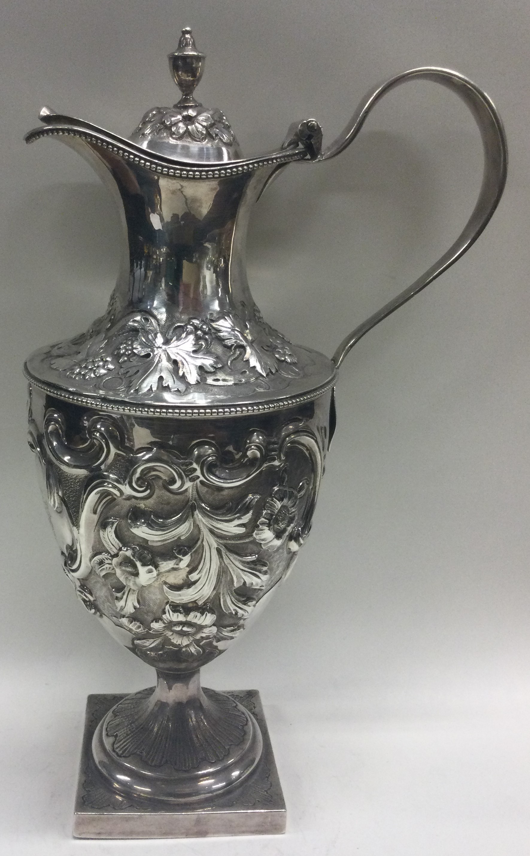 A large chased 18th Century silver wine jug with central armorial. London 1777. - Image 2 of 4