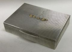 A heavy silver and gold mounted snuff box with engine turned decoration and gilt interior.