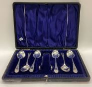 A heavy cased set of six engraved silver teaspoons together with matching tongs. Birmingham.