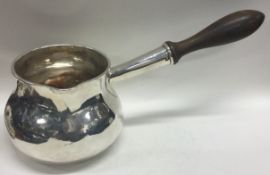 An extremely rare and unique Queen Anne silver brandy pan of substantial proportion.