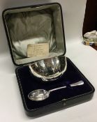 A cased silver christening bowl and spoon. Sheffield 1922. By Walker & Hall.