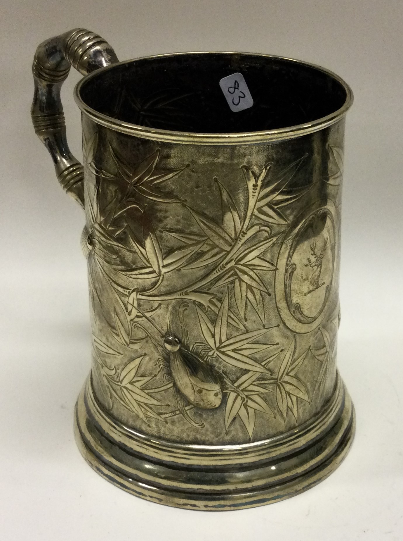 A heavy Chinese silver plated mug embossed with beetles.