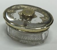 An oval silver gilt dressing table jar. London 1854. By John Harris.
