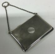 An engine turned silver hinged card case with suspension chain.