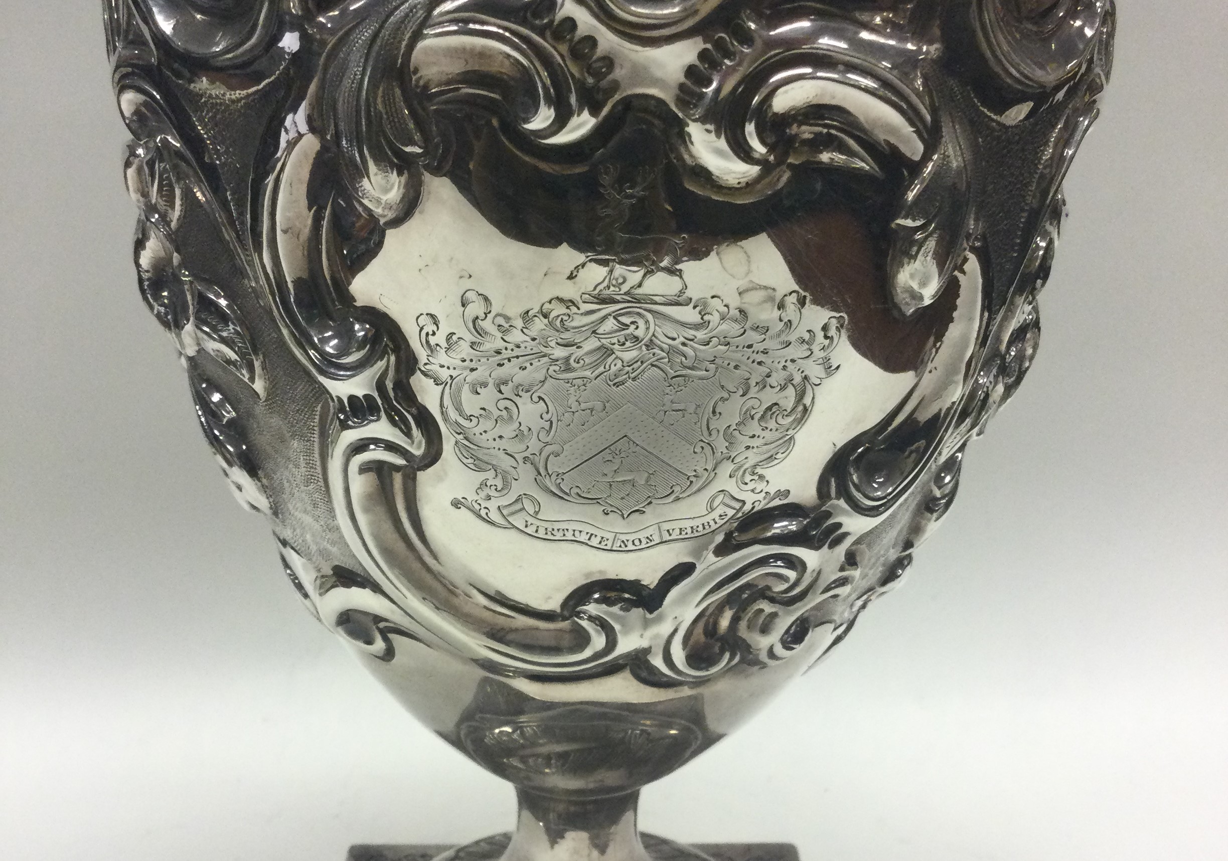 A large chased 18th Century silver wine jug with central armorial. London 1777. - Image 4 of 4
