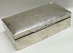 A silver rectangular cigar box with hammered decoration. Birmingham 1908.