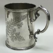 An engraved Victorian Aesthetic movement silver christening mug. London 1869.