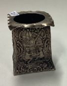 A Continental chased silver candle holder. Marked underneath.
