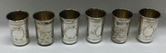 A set of six Continental engraved silver vodka tots.