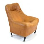 A 1970's Danish tan upholstered bucket chair on later ebonised legs with castors*Sold subject to our