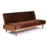 In the manner of Greaves & Thomas, a 1960's teak framed sofa bed upholstered in brown fabric on teak