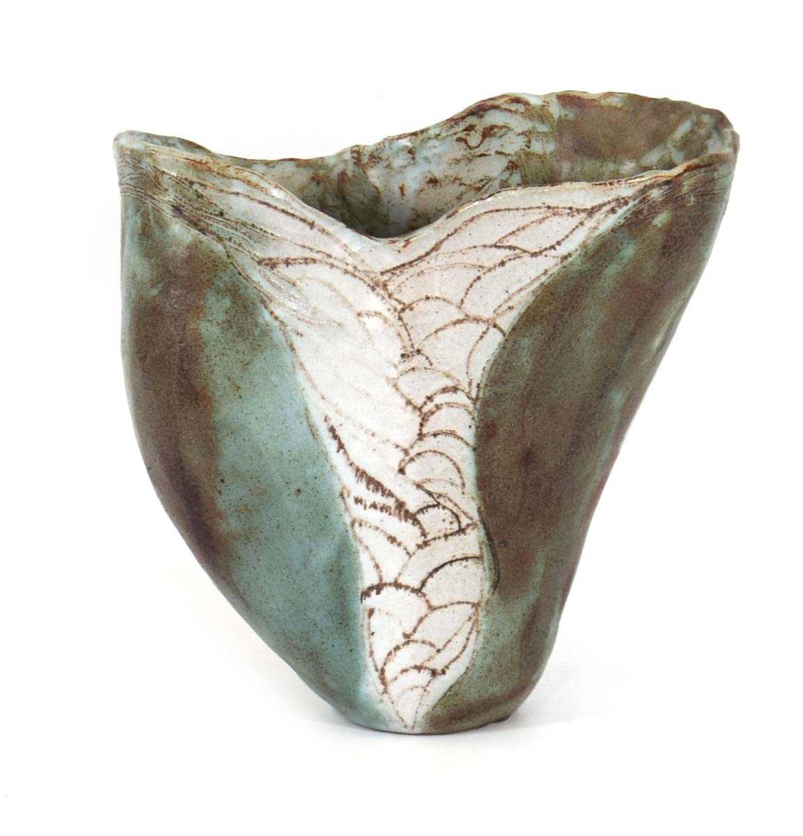 A studio pottery vase of organic form decorated with scales, in the manner of Michael Cardew and