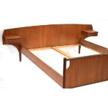 A 1960's Danish teak bedstead with a pair of integral single-drawer bedside cabinets, interior 150 x