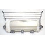 A 1960's tubular wall-mounted hat and coat rack or shelf with a mirrored back, w. 58 cm