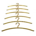 A set of six brass 'kitsch' clothes hangers