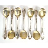 A set of seven Continental parcel gilt metalware fruit spoons decorated in the Neo-Classical manner,