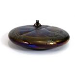 A John Ditchfield iridescent purple glass paperweight in the form of a lily pad decorated with a