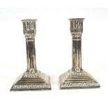 A pair of Victorian silver candlesticks decorated with acanthus leaves in the Neo-Classical
