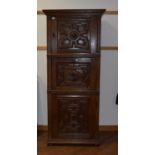 A 17th century style Flemish oak cabinet, the three doors with geometric moulding and figural