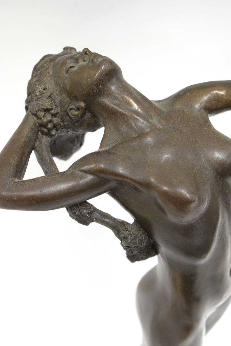 A bronze figure in the Art Deco manner modelled as a nude female standing on a rock holding vines, - Image 2 of 6