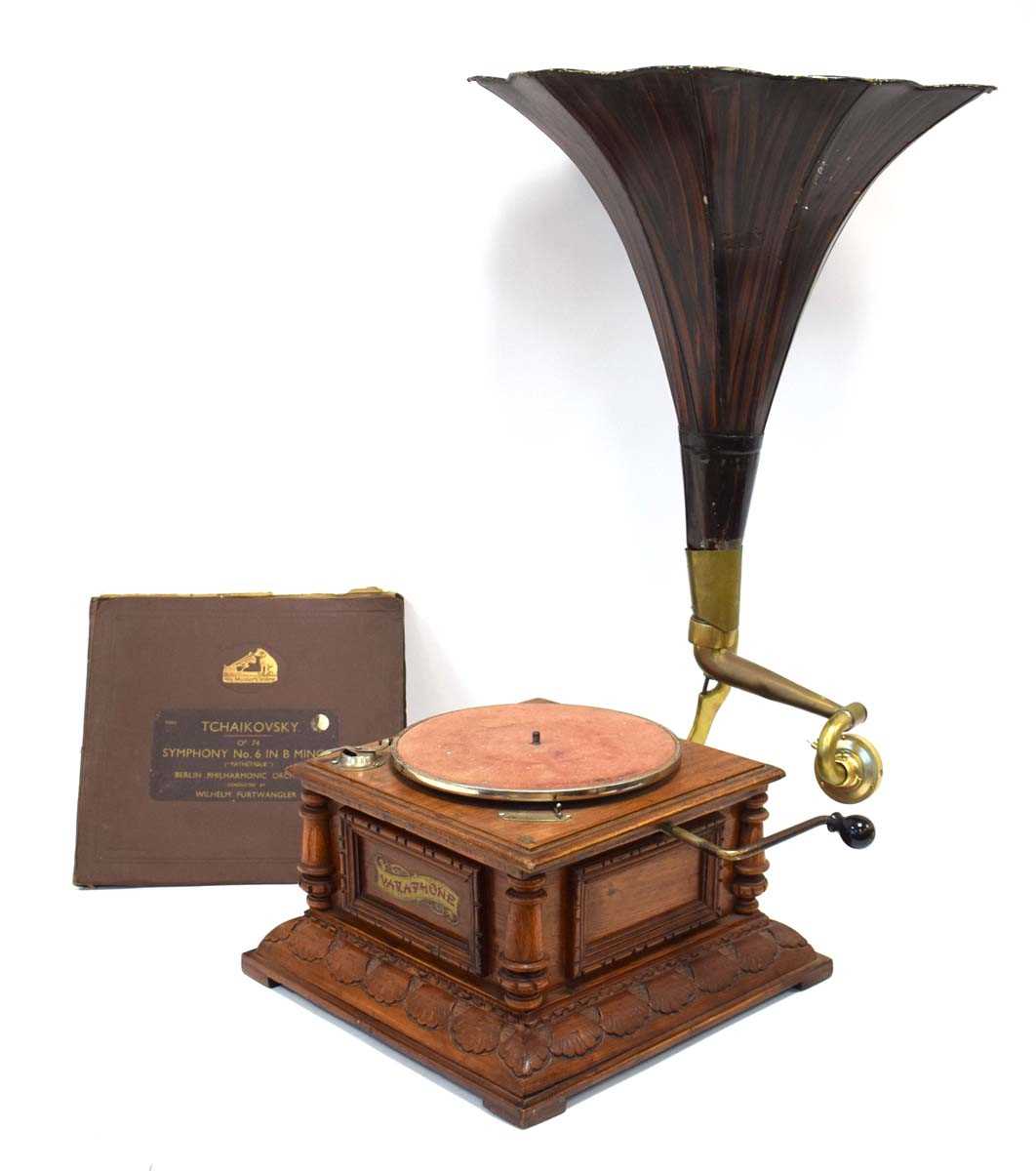 A Varaphone gramophone in a carved walnut case with pressed tin horn, together with a copy of