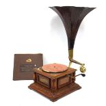 A Varaphone gramophone in a carved walnut case with pressed tin horn, together with a copy of