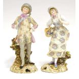 A pair of German porcelain figures modelled as a dandy, a rifle slung over his shoulder, and his