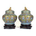 A pair of Chinese champlevé vases and covers, the blue bodies decorated with floral motifs, h. 22