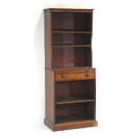A late 19th century mahogany bookcase cabinet, the adjustable shelves over a slide, drawer and