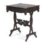 A Victorian oak and tooled leather library table with figural masks, royal emblems and flags, and