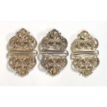 Three early 20th century silver buckles of rococo design, w. 7 cm, overall 1.9 ozs (3)