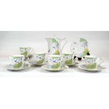 A Czech six-sitting tea service in the Art Deco manner decorated with birds over a sunset